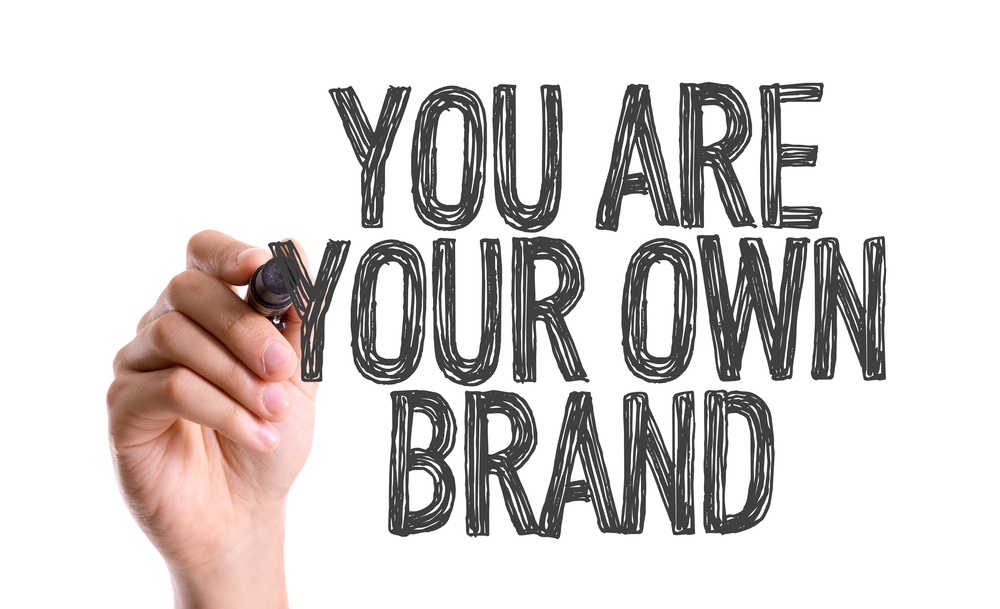 Hand with marker writing You Are Your Own Brand.jpeg